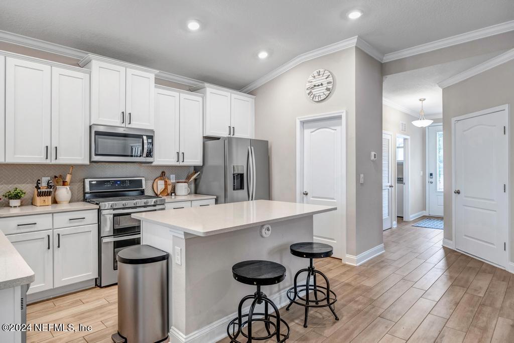 196 Creekmore Drive St. Augustine, FL 32092 - Photo 5 of 51 a kitchen with stainless steel appliances a stove a refrigerator and a sink