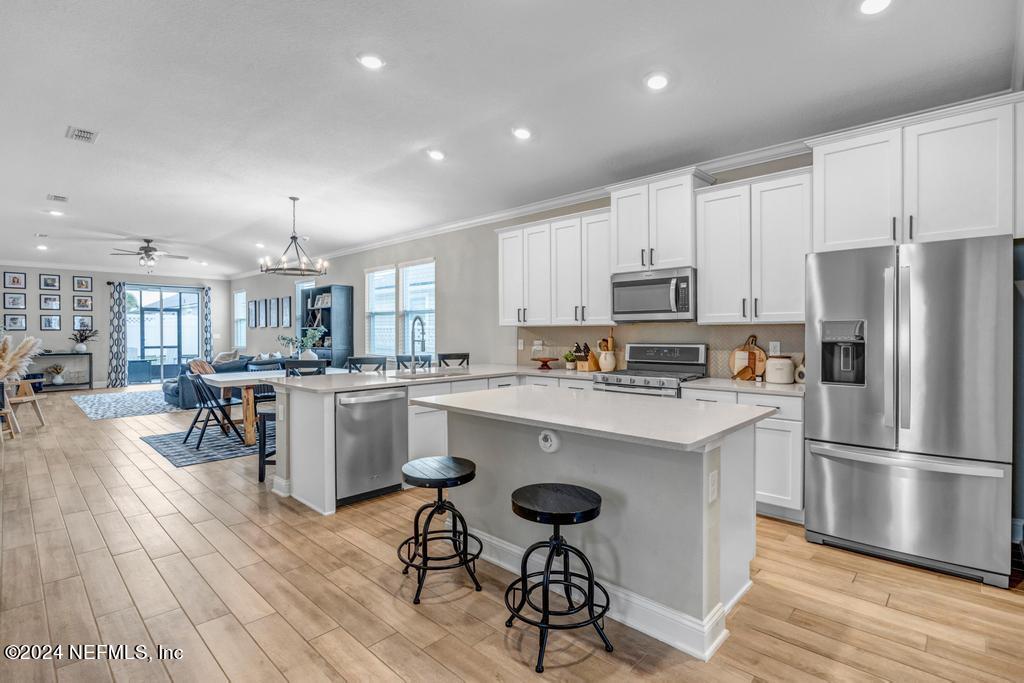 196 Creekmore Drive St. Augustine, FL 32092 - Photo 10 of 51 a kitchen with a sink a counter top stainless steel appliances and cabinets
