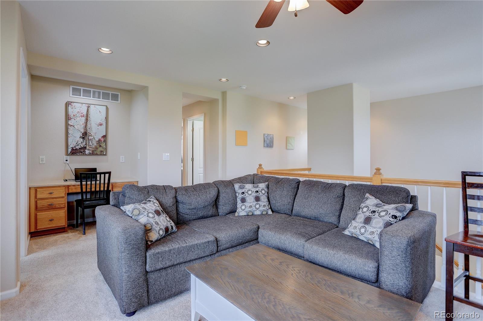 10855 Brooklawn Road Highlands Ranch, CO 80130 - Photo 17 of 37 a living room with furniture and a chandelier
