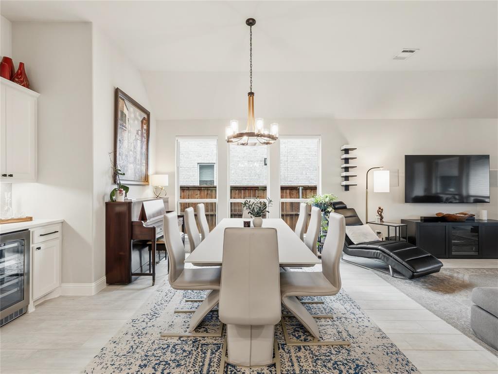 15340 Crape Myrtle Road Frisco, TX 75035 - Photo 7 of 40 Open-concept living area featuring a vaulted ceiling and light-toned flooring