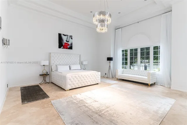 a view of a white house with a yard and potted plants