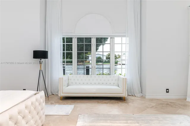 a bedroom with a large bed and a flat tv screen on a dresser