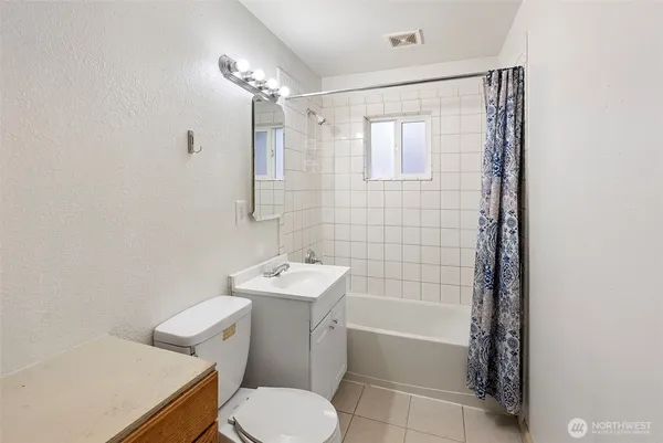 a bathroom with a toilet a sink and bathtub