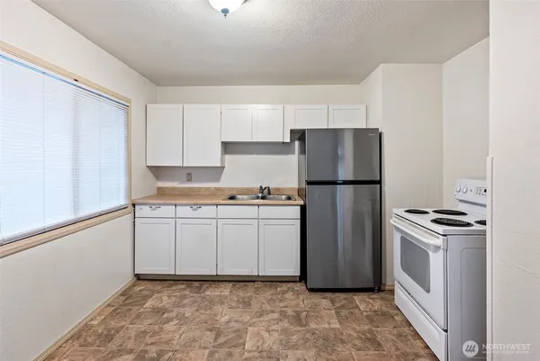 a kitchen with a refrigerator sink and stove