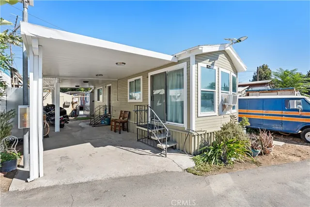 a view of a house with sitting area and garden