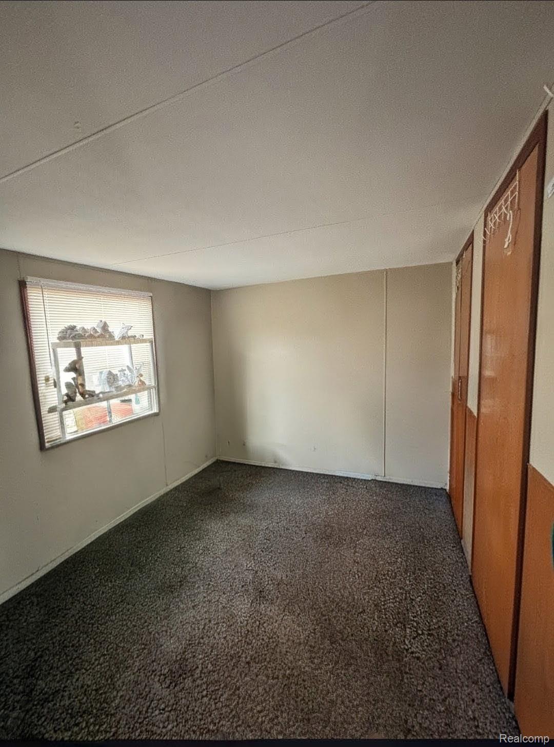246 South Sheridan Road Lennon, MI 48449 - Photo 8 of 12 Unfurnished room featuring dark colored carpet