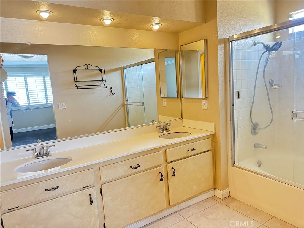 16777 Elk Horn Avenue Chino Hills, CA 91709 - Photo 14 of 20 a bathroom with a shower sink and mirror