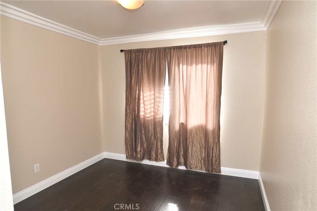16777 Elk Horn Avenue Chino Hills, CA 91709 - Photo 17 of 20 an empty room with wooden floor and windows
