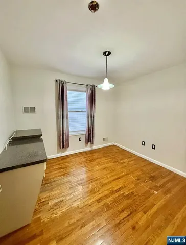 a view of a bedroom with a bed and cabinets