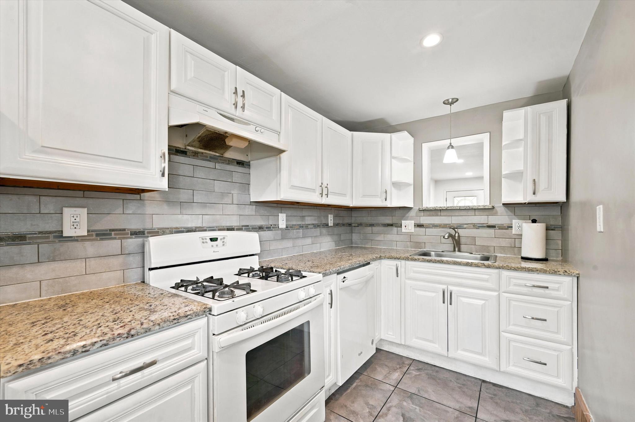 268 Blanchard Road Drexel Hill, PA 19026 - Photo 6 of 15 a kitchen with granite countertop white cabinets and white appliances