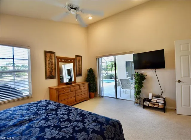 a bedroom with furniture and a flat screen tv