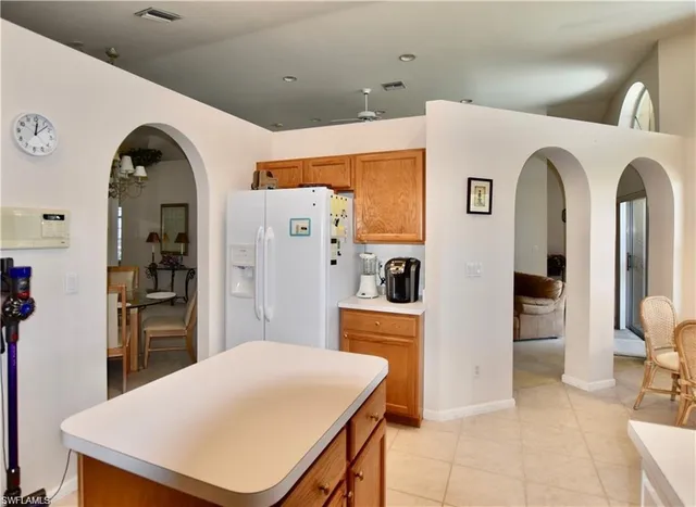 a kitchen with stainless steel appliances kitchen island a refrigerator and sink
