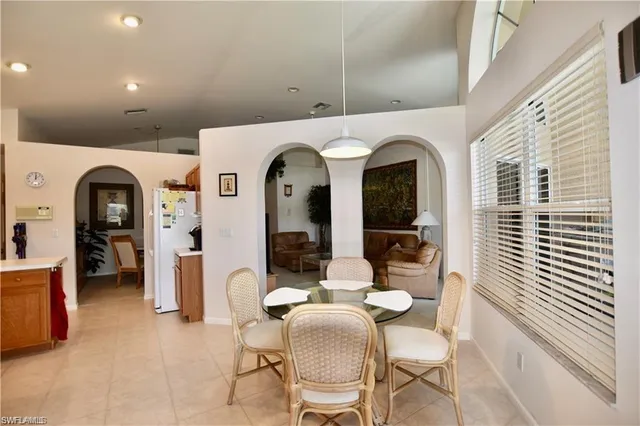 a living room with couches a dining table and chairs with outer view
