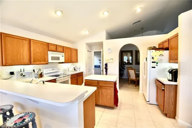 a large white kitchen with a large window