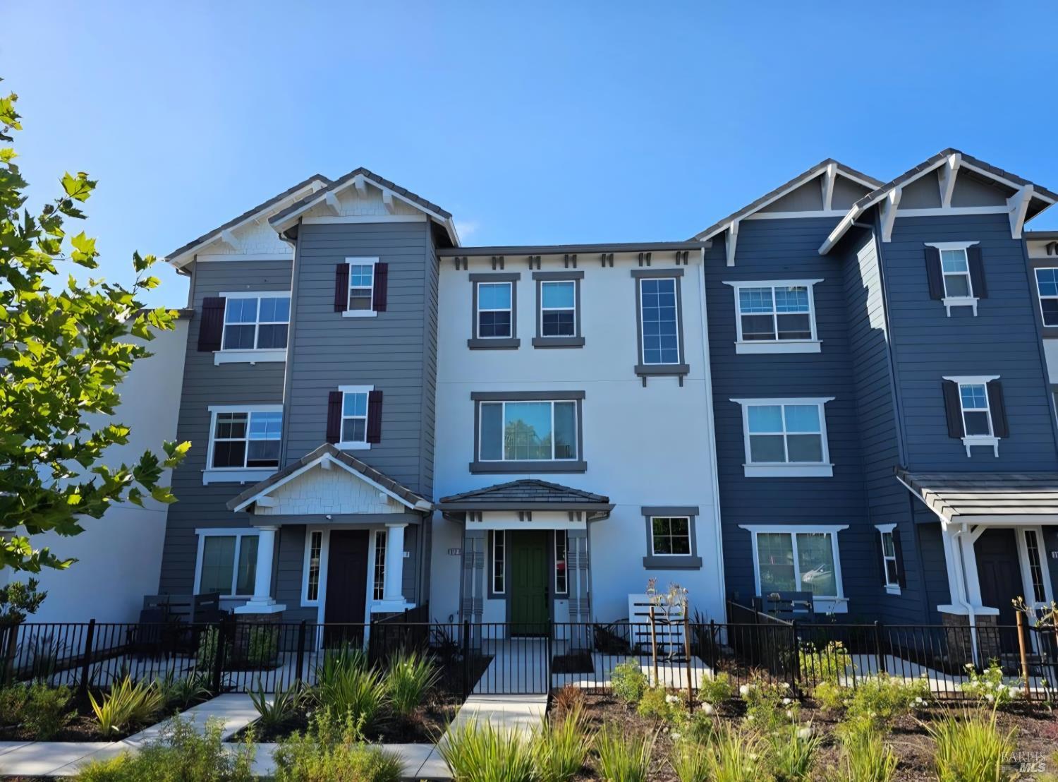 a front view of a house with yard and trees