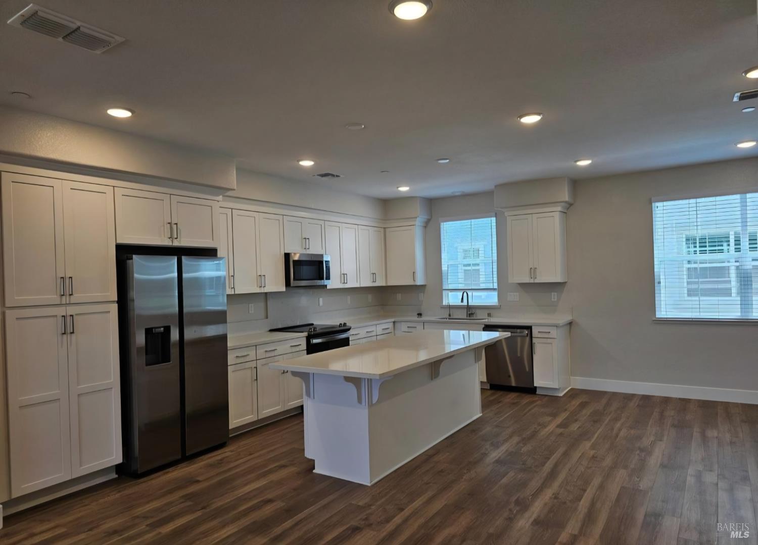 312 Pear Tree Lane, Unit E Napa, CA 94558 - Photo 2 of 5 a large kitchen with stainless steel appliances granite countertop a stove a sink and a refrigerator