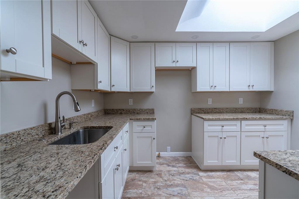 562 Filmore Road Pittsburgh, PA 15221 - Photo 11 of 25 a kitchen with white cabinets appliances and sink