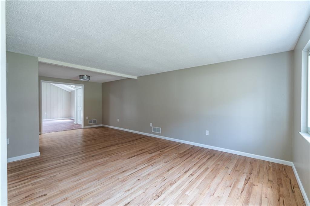 562 Filmore Road Pittsburgh, PA 15221 - Photo 6 of 25 a view of an empty room with wooden floor and a window