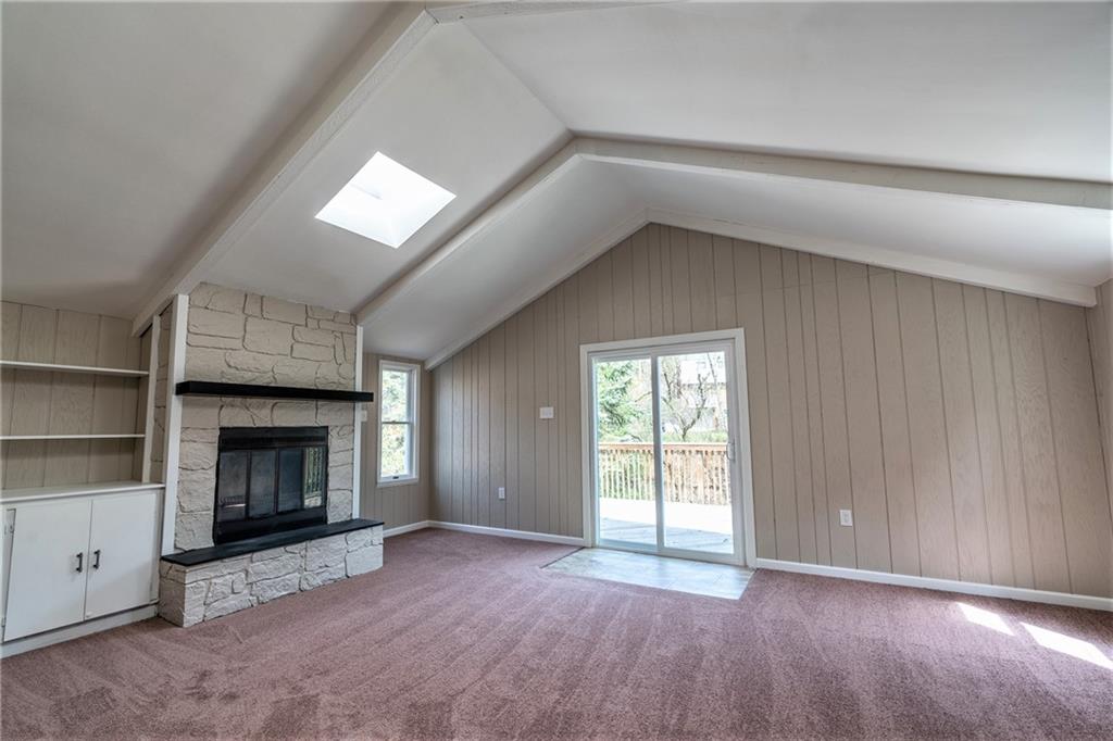 562 Filmore Road Pittsburgh, PA 15221 - Photo 8 of 25 an empty room with windows and fireplace