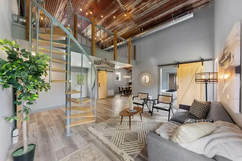 a living room with furniture and a potted plant