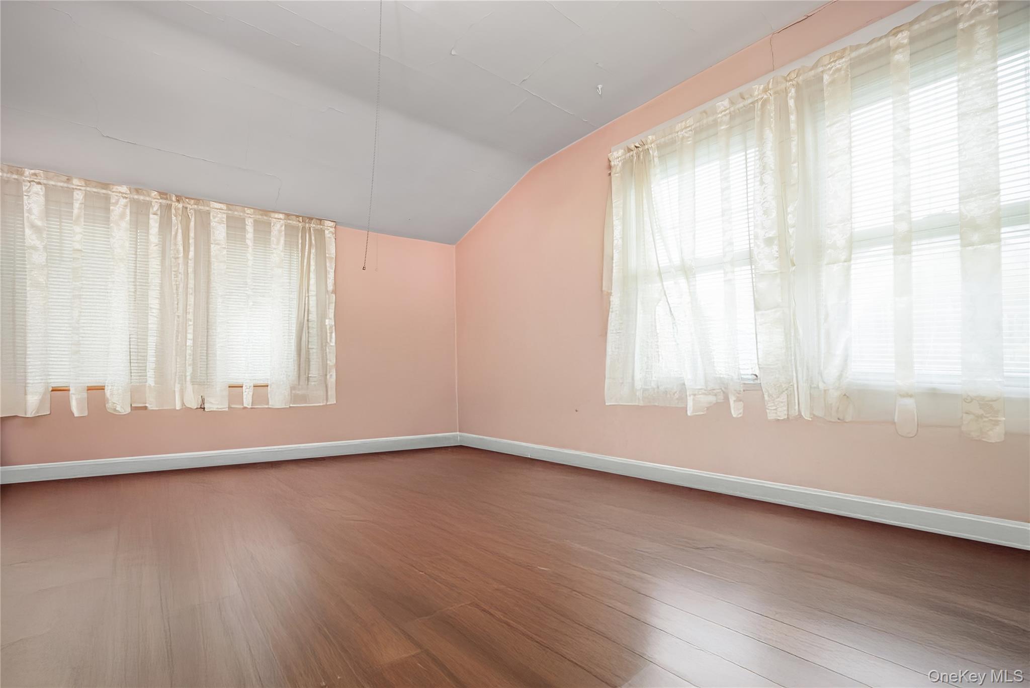 24 Bay 3rd Street Islip, NY 11751 - Photo 12 of 27 an empty room with wooden floor and windows
