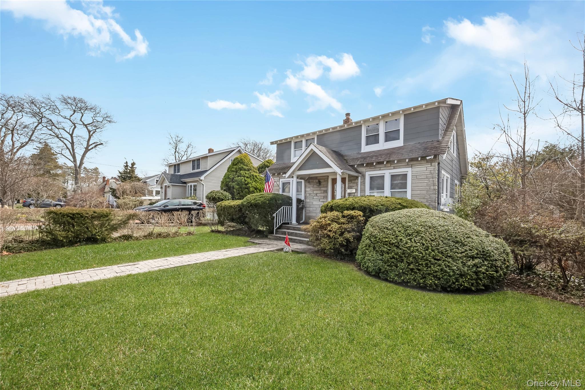 24 Bay 3rd Street Islip, NY 11751 - Photo 2 of 27 a front view of a house with a garden and plants