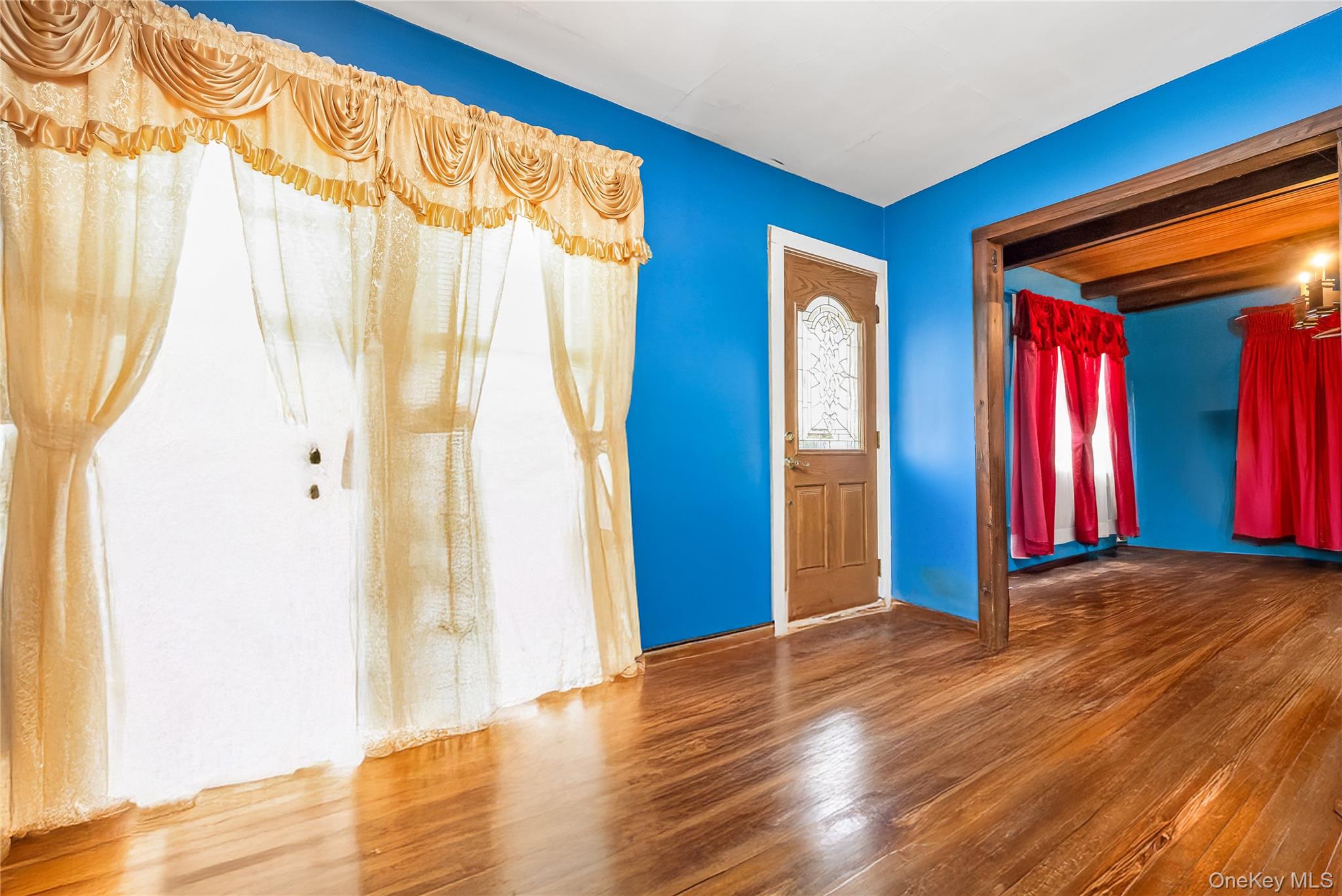 24 Bay 3rd Street Islip, NY 11751 - Photo 3 of 27 a view of an empty room with wooden floor and a window