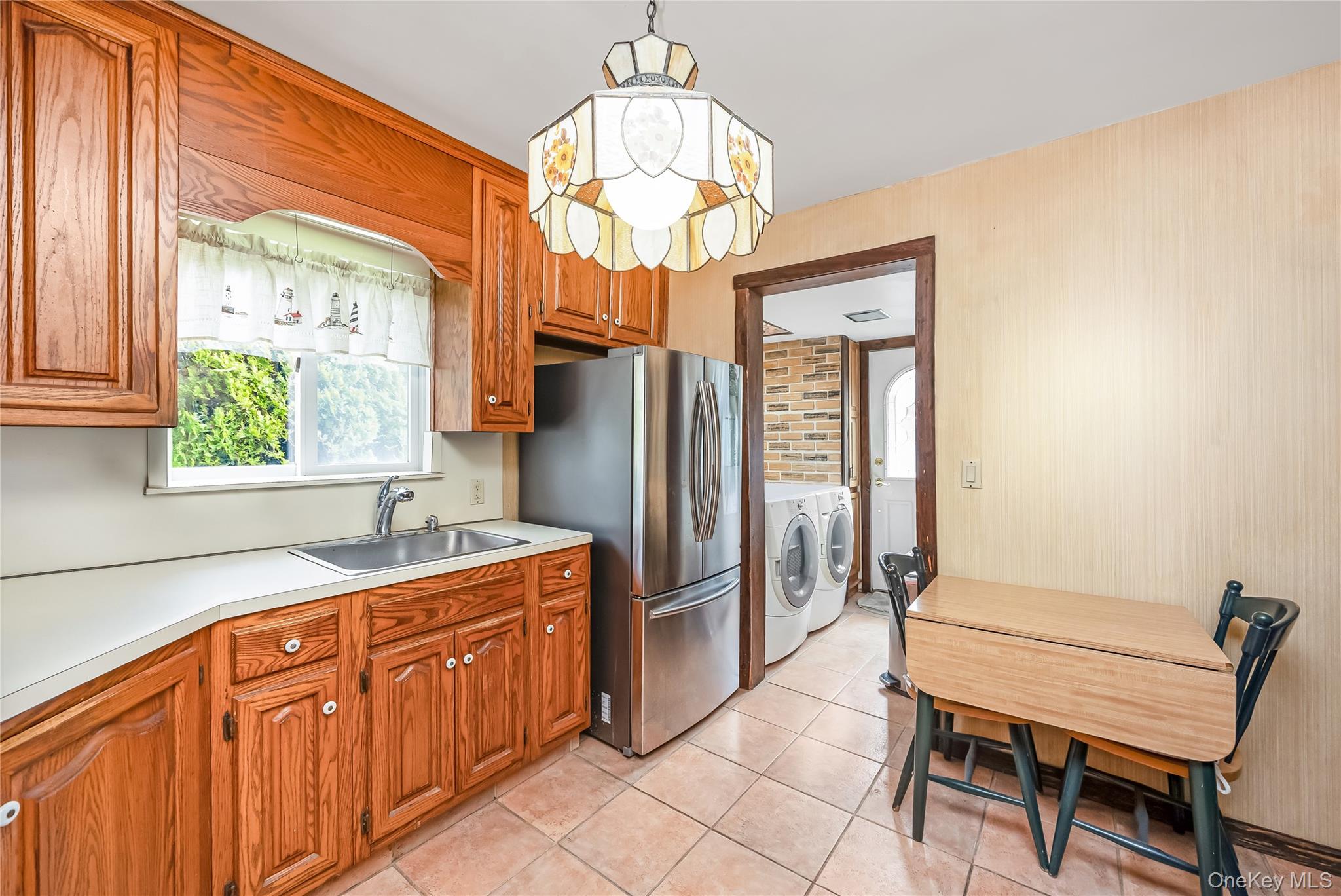24 Bay 3rd Street Islip, NY 11751 - Photo 5 of 27 a kitchen with stainless steel appliances granite countertop a refrigerator and a sink