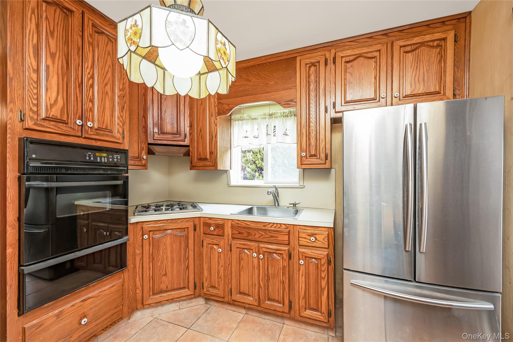 24 Bay 3rd Street Islip, NY 11751 - Photo 6 of 27 a kitchen with stainless steel appliances granite countertop a refrigerator and a sink