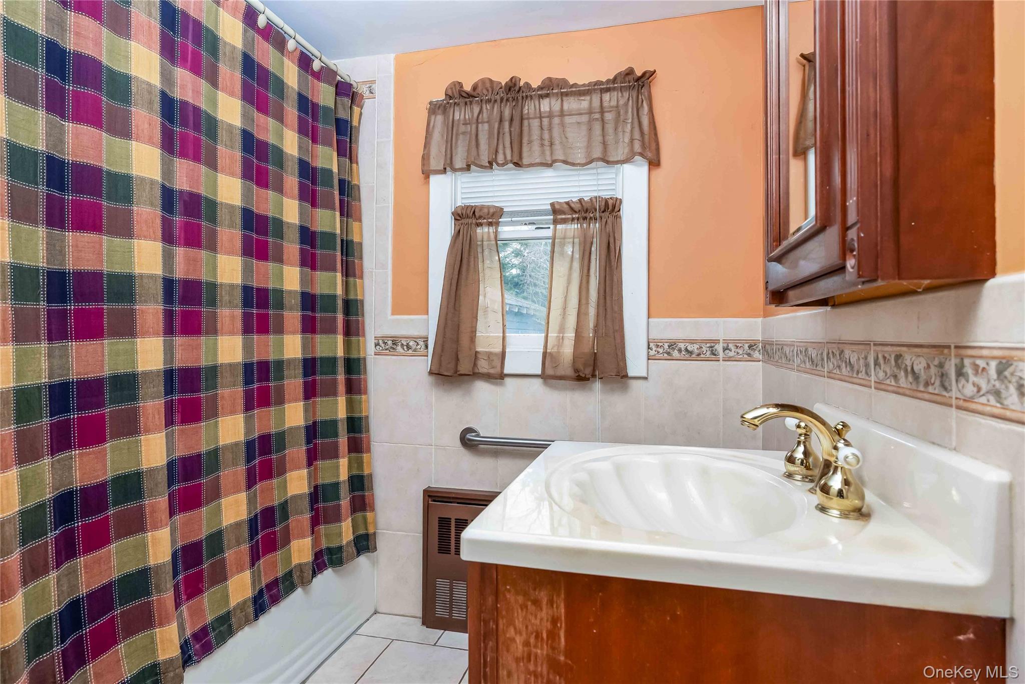 24 Bay 3rd Street Islip, NY 11751 - Photo 7 of 27 a bathroom with a sink and a mirror