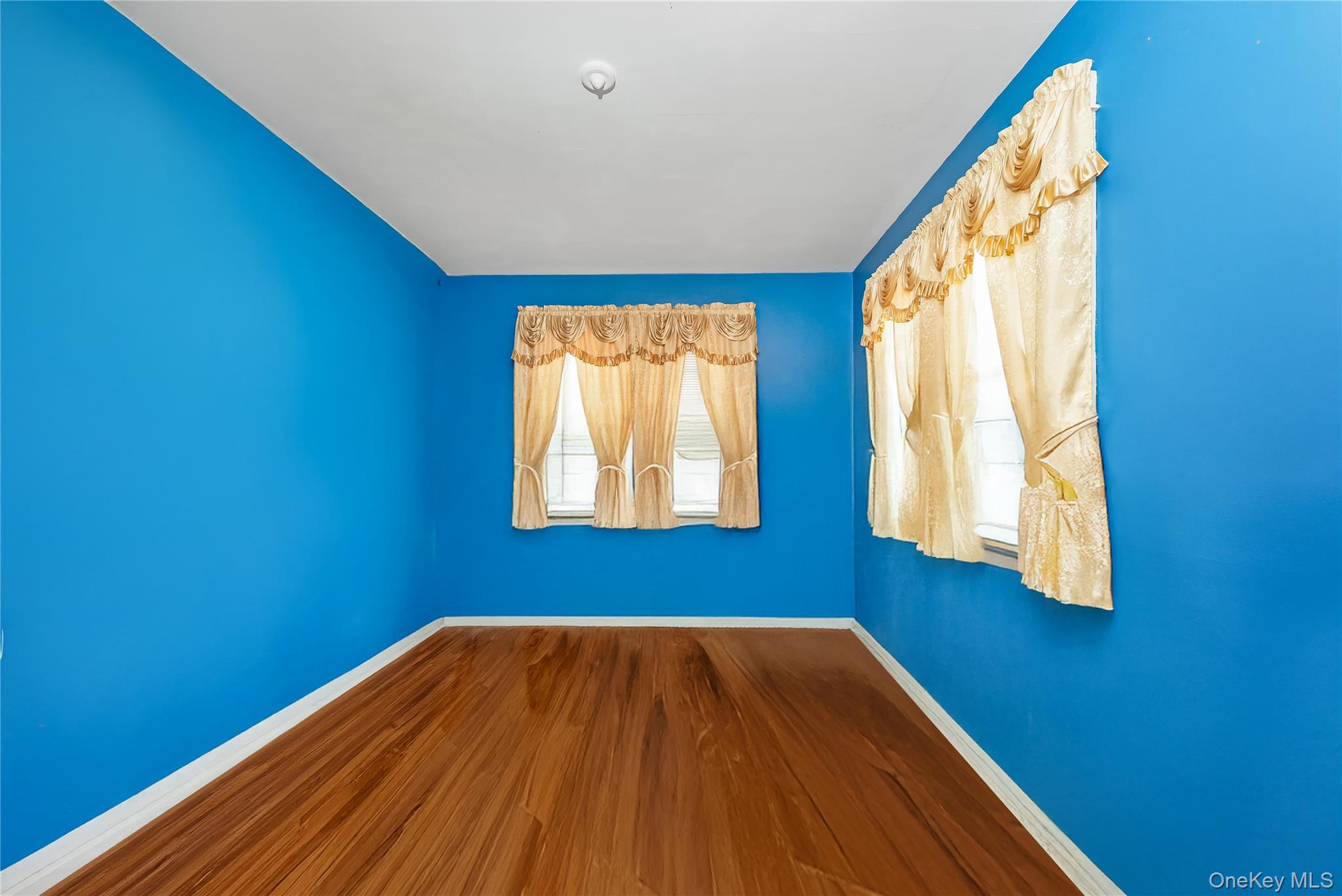 24 Bay 3rd Street Islip, NY 11751 - Photo 10 of 27 a view of a room with wooden floor and windows