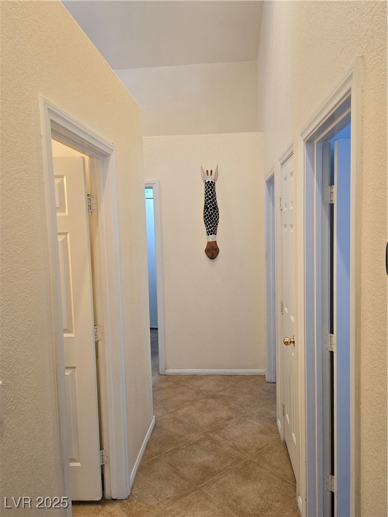 853 Rusty Anchor Way Henderson, NV 89002 - Photo 24 of 76 Hall with tile patterned flooring throughout.