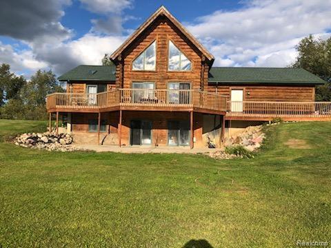 10374 Wilson Road Otisville, MI 48463 - Photo 2 of 99 Rear view of property featuring a wooden deck and a yard