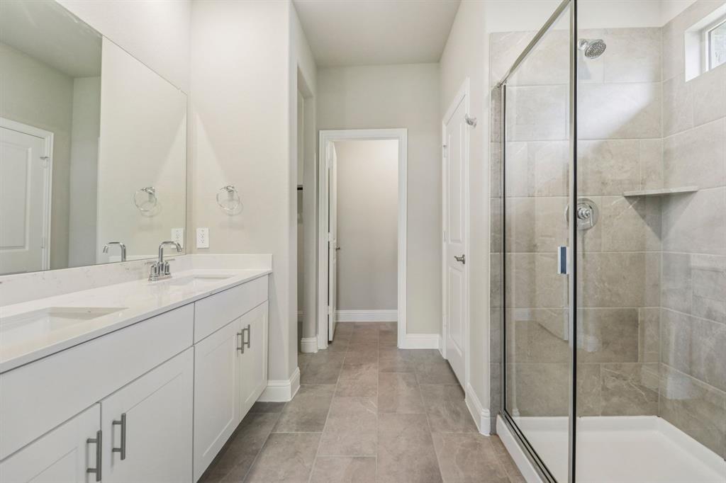 2219 Rannoch Street Sherman, TX 75092 - Photo 15 of 32 a bathroom with a shower sink and mirror