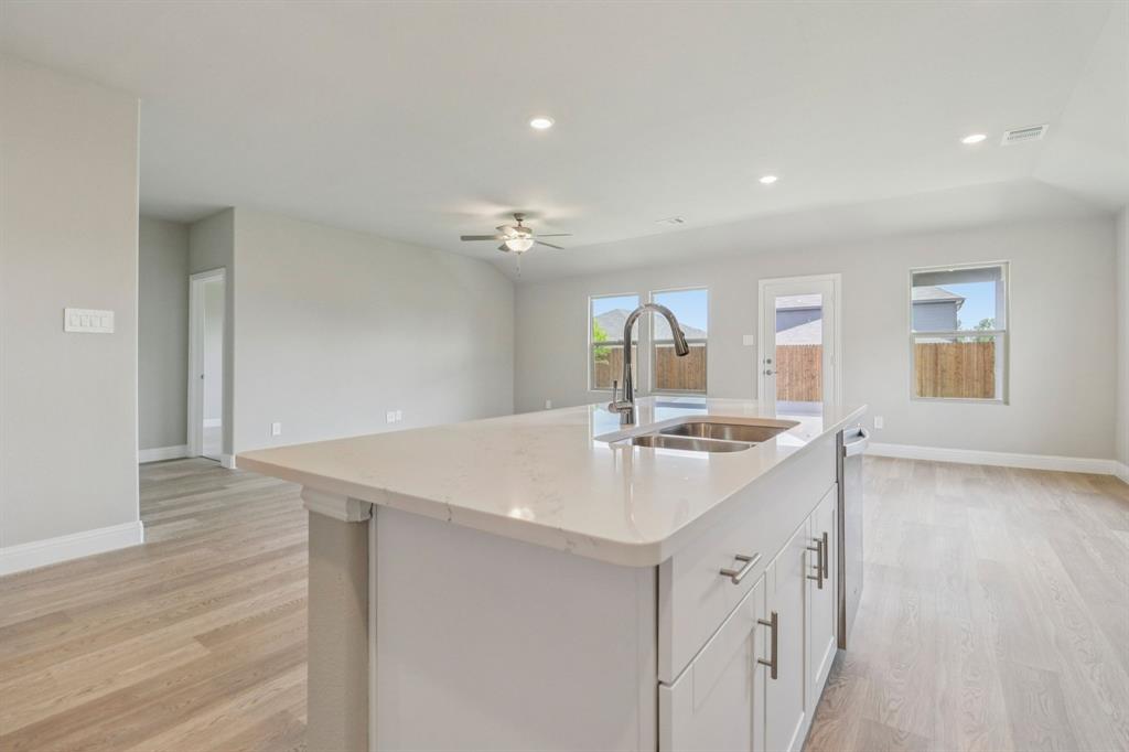 2219 Rannoch Street Sherman, TX 75092 - Photo 5 of 32 a kitchen with a sink and stove