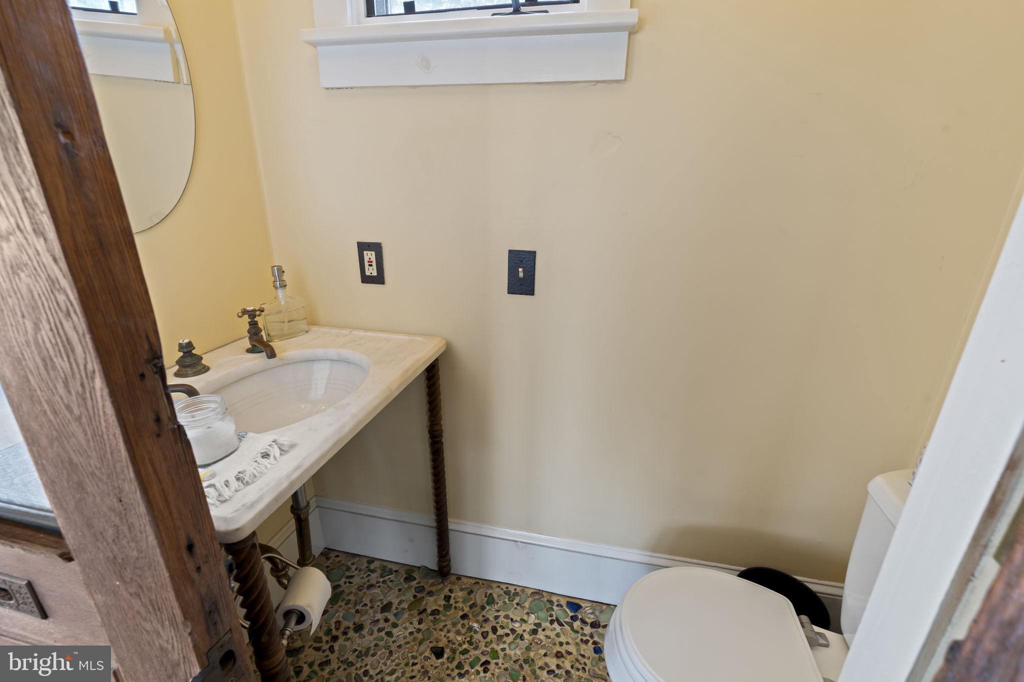 339 Park Avenue Swarthmore, PA 19081 - Photo 22 of 54 a bathroom with a sink a toilet a mirror and vanity