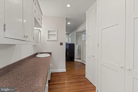 a bathroom with a granite countertop toilet sink mirror vanity and shower