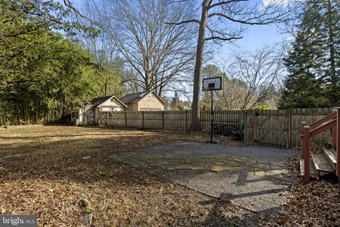 a view of house with a yard