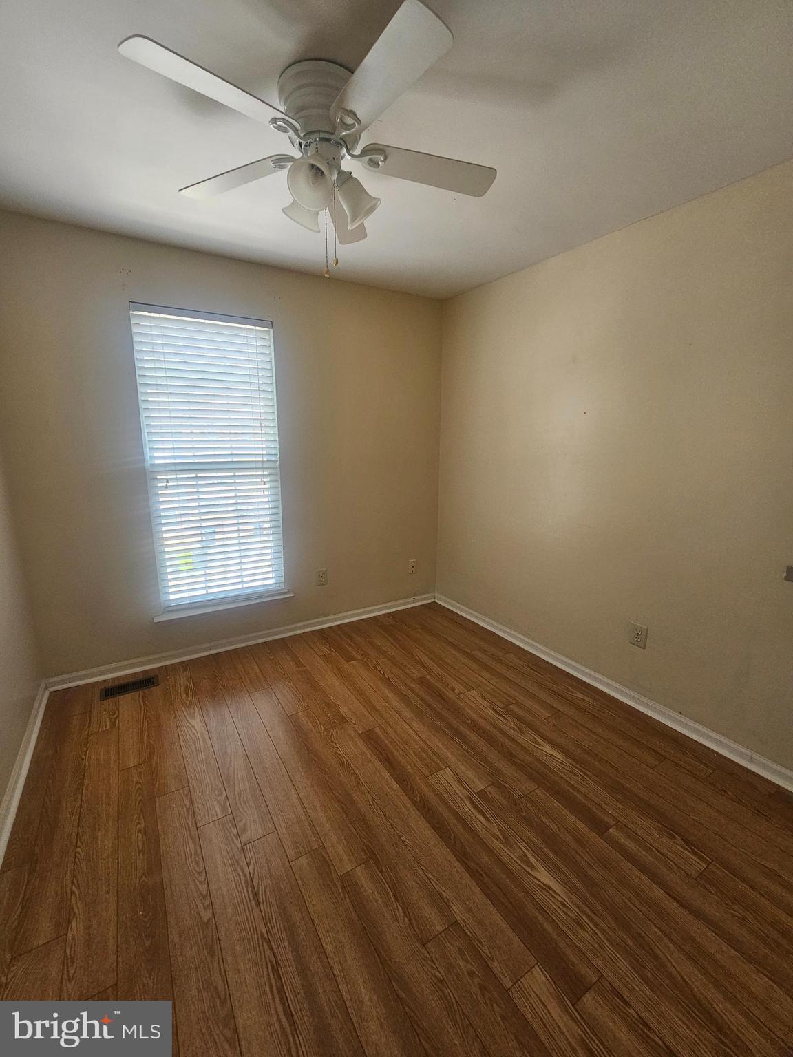 13 Denny Circle Newark, DE 19702 - Photo 14 of 18 wooden floor in an empty room with a window