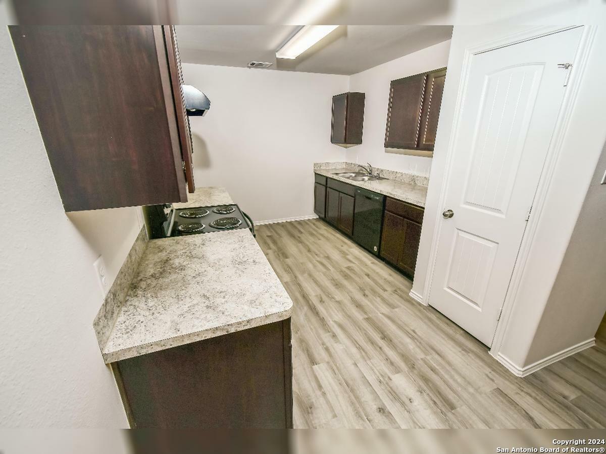 10506 Apple Pie Road San Antonio, TX 78224 - Photo 4 of 14 a kitchen with stainless steel appliances granite countertop a sink stove and refrigerator