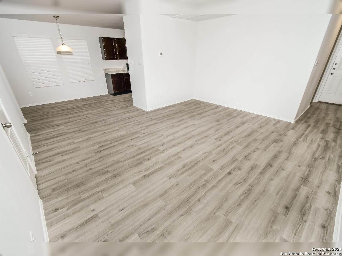 10506 Apple Pie Road San Antonio, TX 78224 - Photo 7 of 14 a view of an empty room with wooden floor