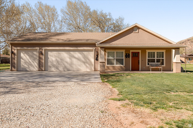 Undisclosed Address Hurricane, UT 84737 - Photo 1 of 1 View of front of property featuring driveway, covered porch, a garage, a front lawn, and a shingled roof