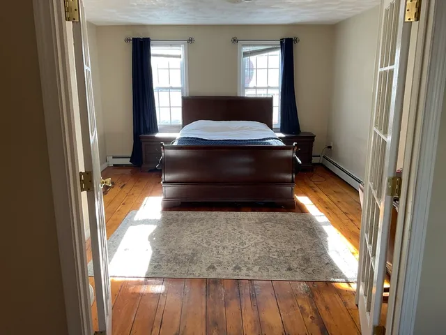 a living room with a bed and a window