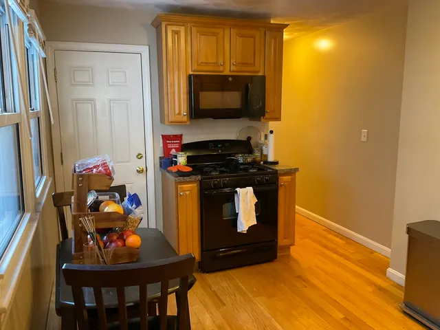 a living room with a bed and a flat screen tv
