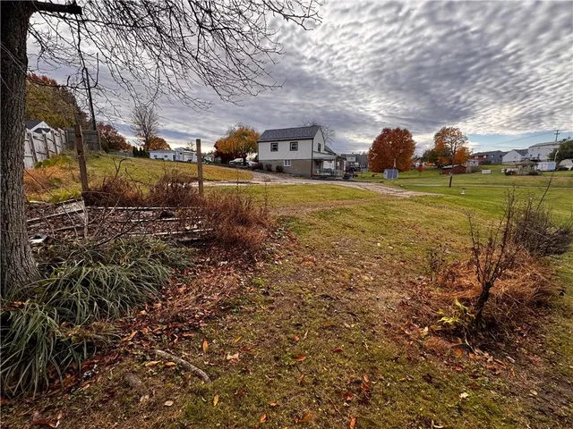 a view of a house with swimming pool and a yard
