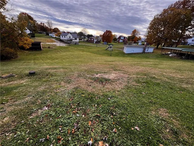 a view of a water fountain and a bench