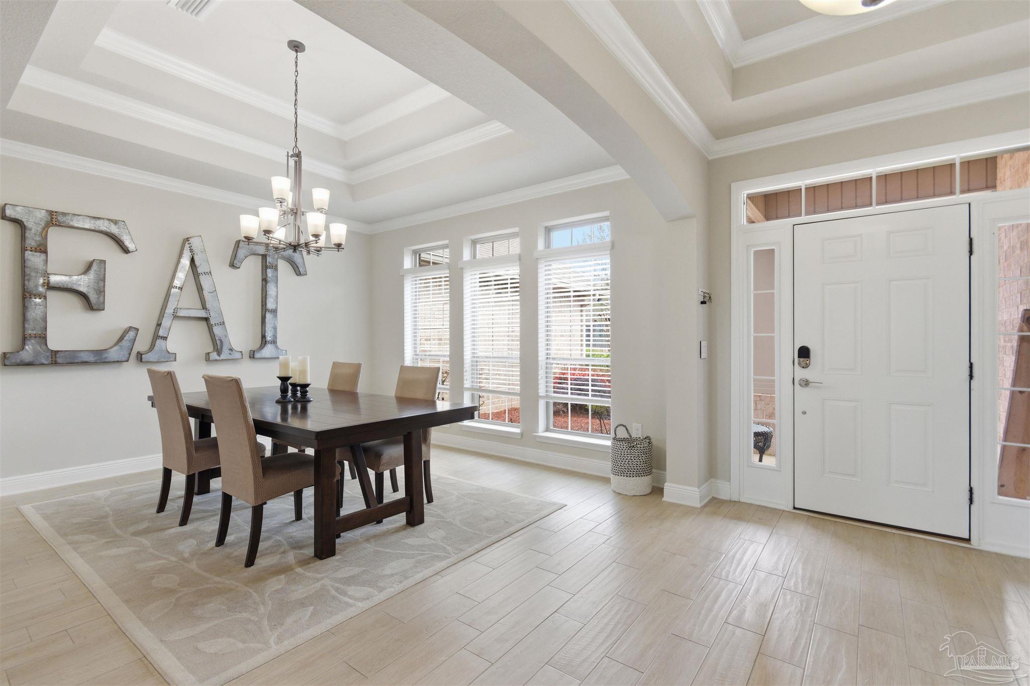 2677 Tulip Hill Road Pace, FL 32571 - Photo 3 of 35 a view of a dining room with furniture and chandelier