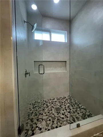 a bathroom with a shower and a sink