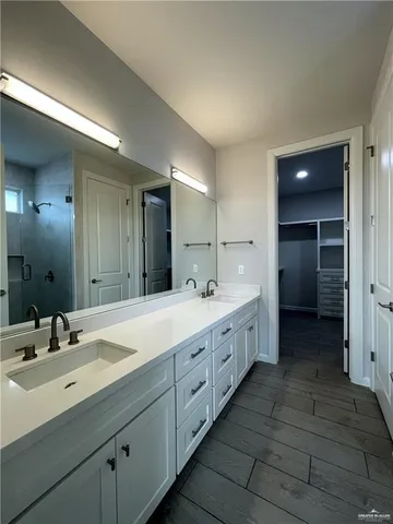 a spacious bathroom with double sink and mirror