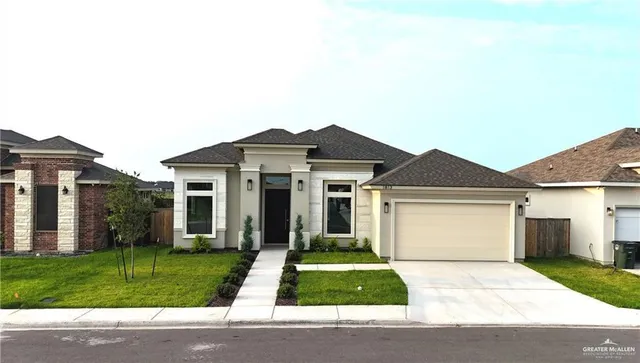 a front view of a house with a yard